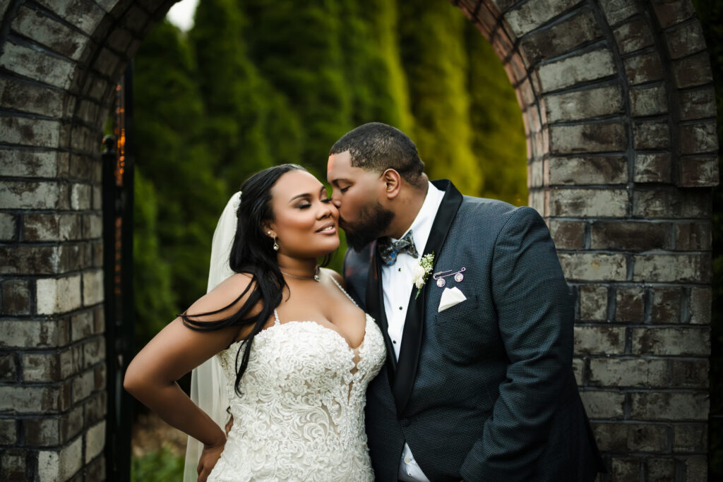 groom kissing bride's cheek